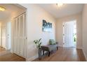 Bright entryway with bench, closet, and wood-look floors at 7213 Las Casas Dr, Sarasota, FL 34243