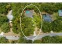 Bird's-eye view of house, pool, and surrounding trees at 7408 Oak Run Ln, Sarasota, FL 34243