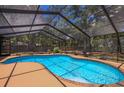 Inviting kidney-shaped pool with screened enclosure at 7408 Oak Run Ln, Sarasota, FL 34243