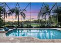 Enclosed pool and spa with stunning sunset view at 7504 Windy Hill Cv, Lakewood Ranch, FL 34202