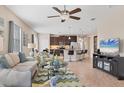 Open floor plan with modern furniture and kitchen island at 8150 Enclave Way # 104, Sarasota, FL 34243