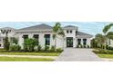 Charming home showcasing manicured landscaping, a paved driveway, and a two-car garage at 8376 Sea Glass Ct, Sarasota, FL 34240