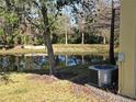 Water view of pond with trees and an AC unit at 8889 White Sage Loop, Lakewood Ranch, FL 34202