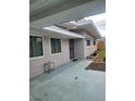 House entrance with light teal concrete walkway at 2001 32Nd W St, Bradenton, FL 34205