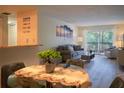 Dining area with glass-top table and view into living room at 3223 Beneva Rd # 201, Sarasota, FL 34232