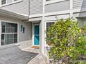 Teal front door with seahorse decor, and flowering bush at 3523 52Nd W Ave, Bradenton, FL 34210