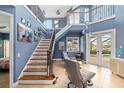 Grand two-story foyer with elegant staircase, and access to the backyard pool at 3607 Darin Dr, Punta Gorda, FL 33950