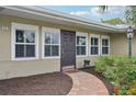 Front door entrance with brick walkway and landscaping at 430 Beach Park Blvd, Venice, FL 34285