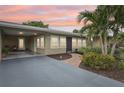 House exterior at dusk with walkway and landscaping at 430 Beach Park Blvd, Venice, FL 34285