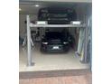 Two-car garage with a car lift system at 5125 Tidewater Preserve Blvd, Bradenton, FL 34208