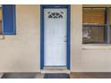 White front door with blue trim and blue shutters at 5659 Saint Louis Ave, Sarasota, FL 34233