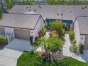 An aerial view showcasing a villa with a private courtyard and lush tropical landscaping at 5958 Clubside Dr, Sarasota, FL 34243