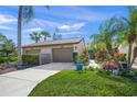 Villa exterior boasts attached garage, attractive landscaping, and a welcoming entrance at 5958 Clubside Dr, Sarasota, FL 34243