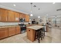 Modern kitchen with granite countertops, stainless steel appliances, and an island at 6519 Rosehill Farm Run, Bradenton, FL 34211