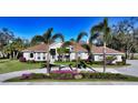 Single-story home with tile roof, landscaping, and circular driveway at 7419 Albert Tillinghast Dr, Sarasota, FL 34240