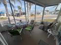 Relaxing screened porch with seating for four and view of community at 817 S Green Cir, Venice, FL 34285