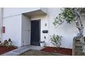 Condo building exterior showcasing the entrance and surrounding landscape at 1007 Longfellow Cir, Sarasota, FL 34243