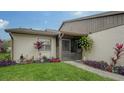 Condo features a screened entryway and lush landscaping at 205 Oak Hill Dr # 7, Sarasota, FL 34232