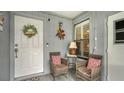 Inviting entryway with seating area and charming decor at 205 Oak Hill Dr # 7, Sarasota, FL 34232