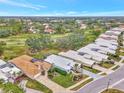 Wide shot of houses near golf course with spacious lots and mature trees at 230 Vestavia Dr, Venice, FL 34292