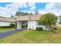 Front view of white single-story home with carport at 2325 Riverbluff Pkwy # V247, Sarasota, FL 34231