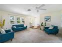 Bright living room featuring teal sofas and entryway at 33931 Serene Dr, Punta Gorda, FL 33982