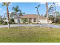 Single-story home with circular driveway and lush lawn at 470 Cedar St, Englewood, FL 34223