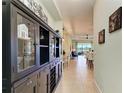Hallway with built-in storage and view into dining area at 4716 Foxtail Dr, Parrish, FL 34219