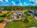 Luxury home with a large lot, landscaping, and palm trees at 4986 Antiquity Way, Sarasota, FL 34240