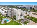 Aerial view of condo building with pool and beach access at 5830 Midnight Pass Rd # 502, Sarasota, FL 34242