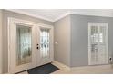 Bright entryway with double doors and white shutters at 605 Wild Turkey Ln, Sarasota, FL 34236