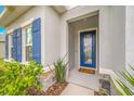 Front entry with blue door and stone accents at 6609 114Th E Ave, Parrish, FL 34219