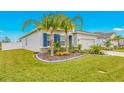 Landscaped front yard with palm trees and curb appeal at 6609 114Th E Ave, Parrish, FL 34219