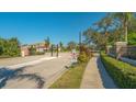 Gated community entrance with brick pillars and a security gate for residents at 6630 Horned Owl Pl, Sarasota, FL 34241