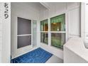 Condo entryway with door, screen, and window showing a glimpse inside at 829 Audubon Dr # 829, Bradenton, FL 34209