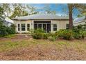 Home's back with screened porch and lush landscaping at 96 Tall Trees Ct, Sarasota, FL 34232