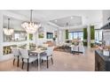 Bright dining area with a large chandelier and seating for six at 10133 Silent Night Ln, Sarasota, FL 34241