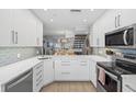 Modern kitchen with white cabinets and quartz countertops at 1275 Siesta Bayside Dr # 1275, Sarasota, FL 34242