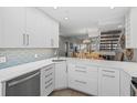 Modern kitchen with white cabinets and quartz countertops at 1275 Siesta Bayside Dr # 1275, Sarasota, FL 34242
