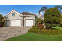 Single-story home with a three-car garage and nicely landscaped front yard at 12821 Indigo Way, Bradenton, FL 34211