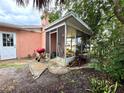 Screened patio with flagstone flooring and various potted plants at 1741 Font Ln, Holiday, FL 34691