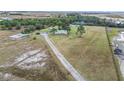 Aerial view showing home, driveway, and surrounding land at 19990 E State Road 64, Bradenton, FL 34212