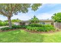 Ranch style home with lush landscaping and a fenced yard at 2502 Alpine Ave, Sarasota, FL 34239