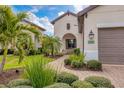 Front entry of home with walkway and landscaping at 26954 Pavin Dr, Englewood, FL 34223