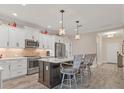 Modern kitchen with island, white cabinets, and stainless steel appliances at 26954 Pavin Dr, Englewood, FL 34223