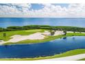 Aerial view of a beautiful golf course with water features at 3060 Grand Bay Blvd # 175, Longboat Key, FL 34228