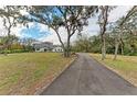 Long paved driveway leading to a charming house nestled among trees at 3514 62Nd E St, Bradenton, FL 34208