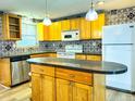 Modern kitchen with wood cabinets and a large island at 360 Flamingo Rd, Venice, FL 34293