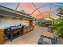 Outdoor kitchen, hot tub, and fire pit create a relaxing backyard oasis at 3712 62Nd E Ave, Bradenton, FL 34203