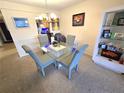 Dining area with glass table and built-in shelving at 3805 E Bay Dr # 302, Holmes Beach, FL 34217
